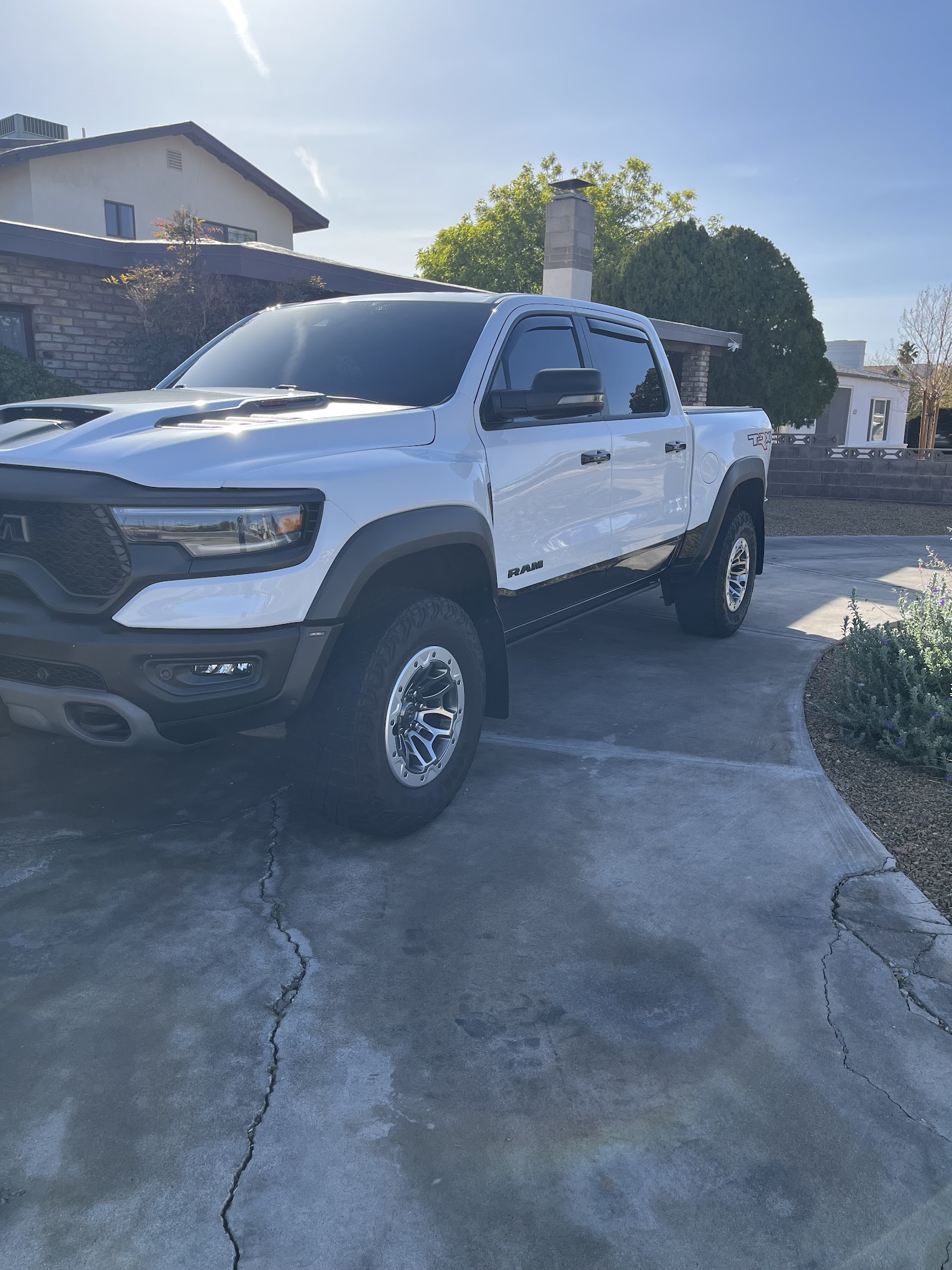Freshly detailed white Ram TRX truck, glossy, in a residential driveway